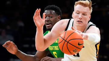 Iowa forward Even Brauns (0) reaches for the basketball in front of Oregon guard TJ Bamba (5) Wednesday, Feb. 19, 2025 at Carver-Hawkeye Arena in Iowa City, Iowa.