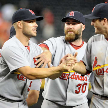 May. 7, 2012; Phoenix, AZ, USA; St. Louis Cardinals outfielder Skip Schumaker (55) , pitcher  Jason Motte (30) and infielder David Freese (23) celebrate after defeating the Arizona Diamondbacks at Chase Field. The Cardinals defeated the Diamondbacks 9-6. Mandatory Credit: Jennifer Stewart-Imagn Images