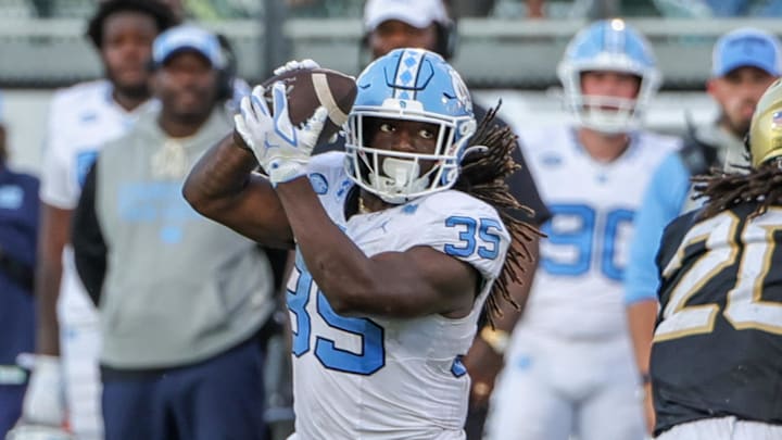 Sep 20, 2025; Orlando, Florida, USA; North Carolina Tar Heels running back Demon June (12) catches a pass during the second half against the UCF Knightsat the Bounce House Stadium. Mandatory Credit: Mike Watters-Imagn Images