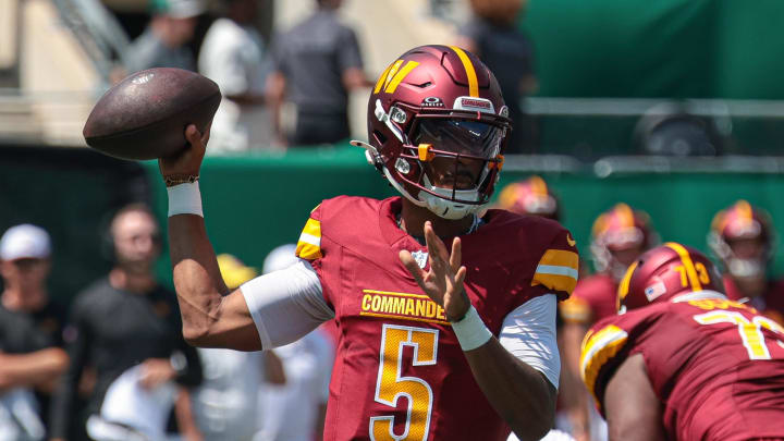 Aug 10, 2024; East Rutherford, New Jersey, USA; Washington Commanders quarterback Jayden Daniels (5) throws the ball during the first quarter against the New York Jets at MetLife Stadium. Mandatory Credit: Vincent Carchietta-USA TODAY Sports