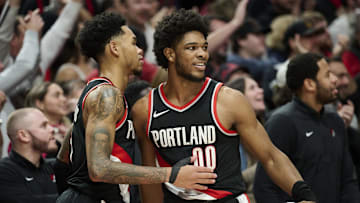 Jan 31, 2024; Portland, Oregon, USA; Portland Trail Blazers guard Scoot Henderson (00) celebrates with guard Anfernee Simons (1) during the second half against the Milwaukee Bucks at Moda Center. Mandatory Credit: Troy Wayrynen-Imagn Images