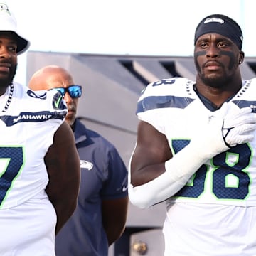 Aug 17, 2024; Nashville, Tennessee, USA; Seattle Seahawks linebacker Derick Hall (58) and teammates stand for the National Anthem before the game against the Tennessee Titans at Nissan Stadium.