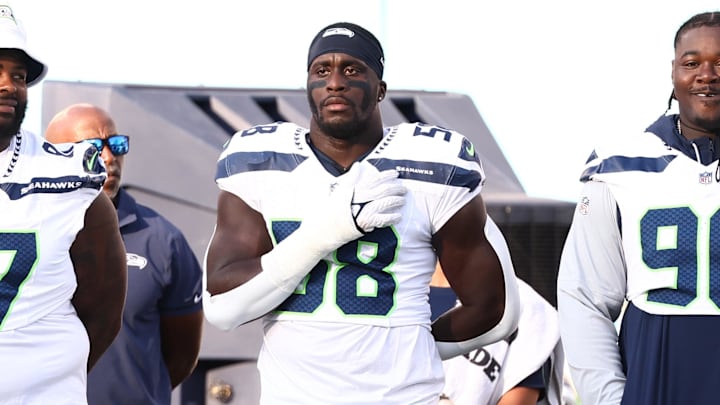 Aug 17, 2024; Nashville, Tennessee, USA; Seattle Seahawks linebacker Derick Hall (58) and teammates stand for the National Anthem before the game against the Tennessee Titans at Nissan Stadium.