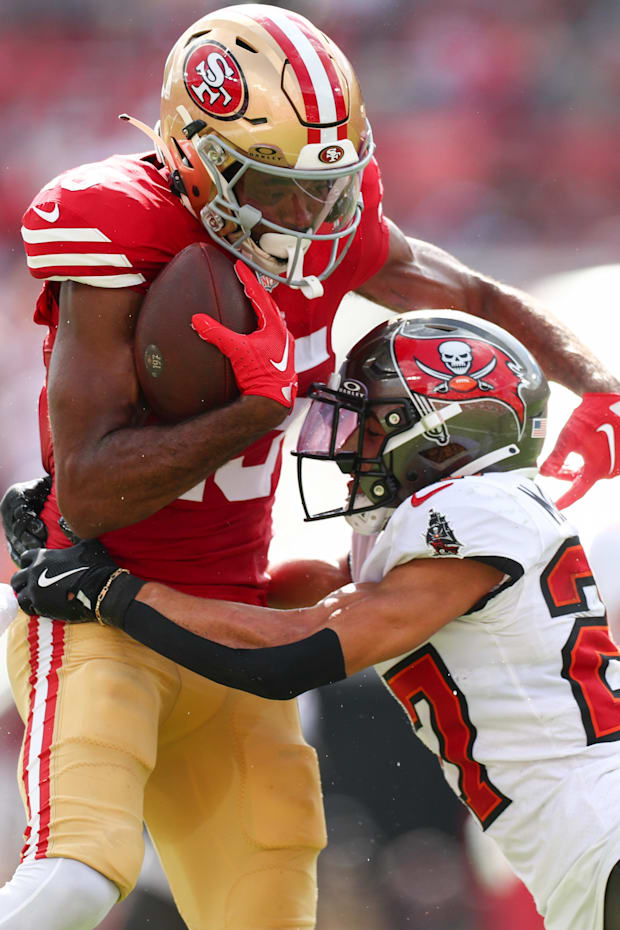 San Francisco 49ers wide receiver Jauan Jennings is tackled by Tampa Bay Buccaneers cornerback Zyon McCollum