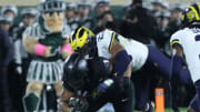 Michigan Wolverines linebacker Michael Barrett (23) tackles Michigan State Spartans defensive back Jaden Mangham (1) during second-half action at Spartan Stadium in East Lansing on Saturday, Oct. 21, 2023.