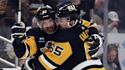 Apr 15, 2024; Pittsburgh, Pennsylvania, USA;  Pittsburgh Penguins center Sidney Crosby (87) and defenseman Erik Karlsson (65) celebrate a goal by Karlsson against the Nashville Predators during the first period at PPG Paints Arena. The Penguins won 4-2. Mandatory Credit: Charles LeClaire-Imagn Images
