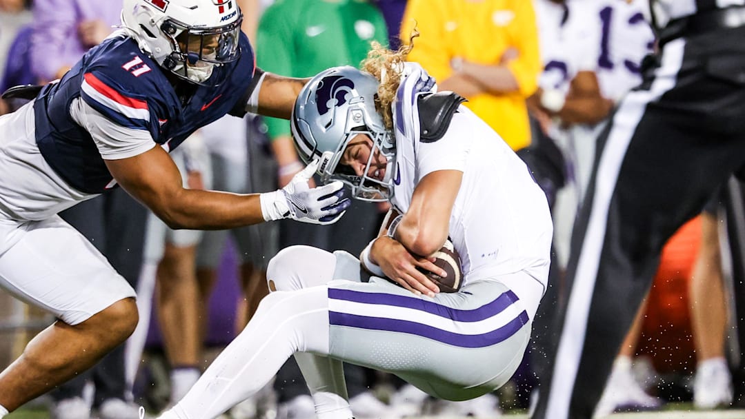 Arizona Wildcats linebacker Jabari Mann tackles Kansas State Wildcats quarterback Avery Johnson. Arizona Wildcats linebacker Jabari Mann tackles Kansas State Wildcats quarterback Avery Johnson.
