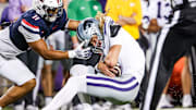 Arizona Wildcats linebacker Jabari Mann tackles Kansas State Wildcats quarterback Avery Johnson.