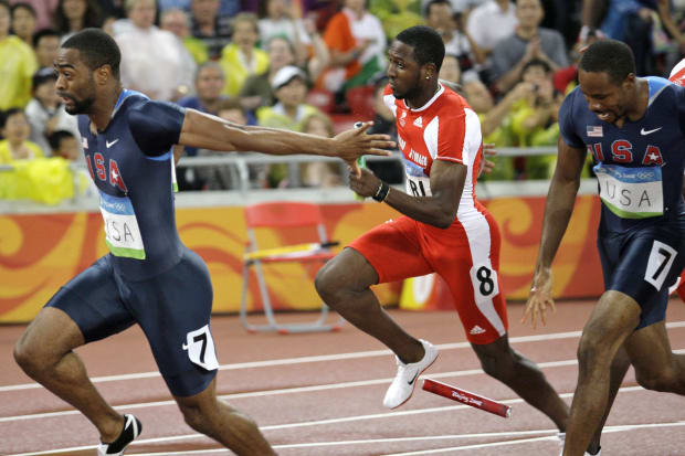 U.S. sprinter Darvis Patton drops the baton while teammate Tyson Gay holds out his in the 4x100 relay at the 2008 Olympics.