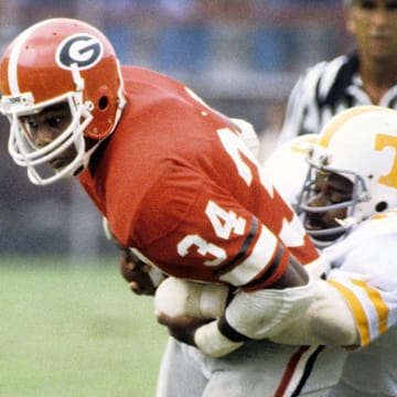 Sep 5, 1981; Athens, GA, USA; FILE PHOTO; Georgia Bulldogs running back Herschel Walker (34) carries the ball against the Tennessee Volunteers at Sanford Stadium. Mandatory Credit: Manny Rubio-Imagn Images.