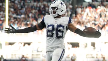 Oct 19, 2025; Arlington, Texas, USA; Dallas Cowboys cornerback Daron Bland (26) carries the ball after an interception for a touchdown against the Washington Commanders during the third quarter of the game at AT&T Stadium.