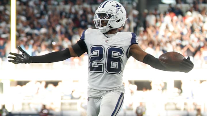 Oct 19, 2025; Arlington, Texas, USA; Dallas Cowboys cornerback Daron Bland (26) carries the ball after an interception for a touchdown against the Washington Commanders during the third quarter of the game at AT&T Stadium.