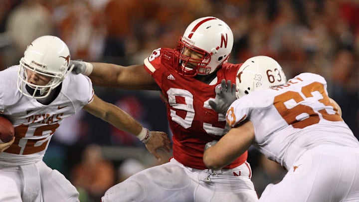 Dec 5, 2009; Arlington, TX, USA; Texas Longhorns quarterback Colt McCoy (12) scrambles to get away from a sack by Nebraska Cornhuskers defensive tackle Ndamukong Suh (93) during the Big 12 championship game at Cowboys Stadium. The Longhorns beat the Cornhuskers 13-12.