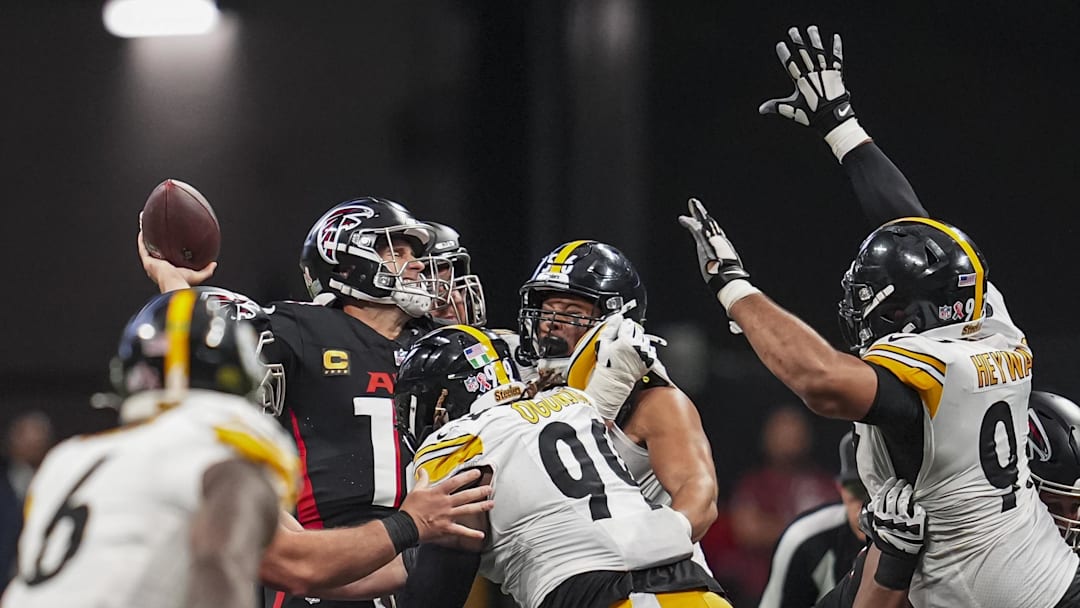 Sep 8, 2024; Atlanta, Georgia, USA; Atlanta Falcons quarterback Kirk Cousins (18) is hit by Pittsburgh Steelers defensive tackle Larry Ogunjobi (99) as he throws during the second half at Mercedes-Benz Stadium. Mandatory Credit: Dale Zanine-Imagn Images