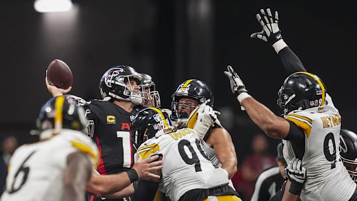 Sep 8, 2024; Atlanta, Georgia, USA; Atlanta Falcons quarterback Kirk Cousins (18) is hit by Pittsburgh Steelers defensive tackle Larry Ogunjobi (99) as he throws during the second half at Mercedes-Benz Stadium. Mandatory Credit: Dale Zanine-Imagn Images