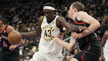 Dec 3, 2024; Toronto, Ontario, CAN; Indiana Pacers forward Pascal Siakam (43) drives to the net against Toronto Raptors center Jakob Poeltl (19) during the second half at Scotiabank Arena. Mandatory Credit: John E. Sokolowski-Imagn Images