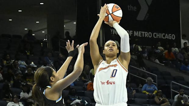 A photo of Satou Sabally shooting over Angel Reese