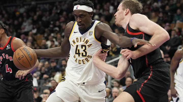 Dec 3, 2024; Toronto, Ontario, CAN; Indiana Pacers forward Pascal Siakam (43) drives to the net against Toronto Raptors center Jakob Poeltl (19) during the second half at Scotiabank Arena. Mandatory Credit: John E. Sokolowski-Imagn Images