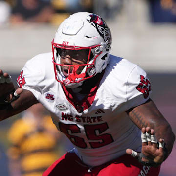 Oct 19, 2024; Berkeley, California, USA; North Carolina State Wolfpack offensive tackle Jacarrius Peak (65) blocks against California Golden Bears linebacker Cheikhsaliou Fall (17) during the second quarter at California Memorial Stadium. Mandatory Credit: Darren Yamashita-Imagn Images