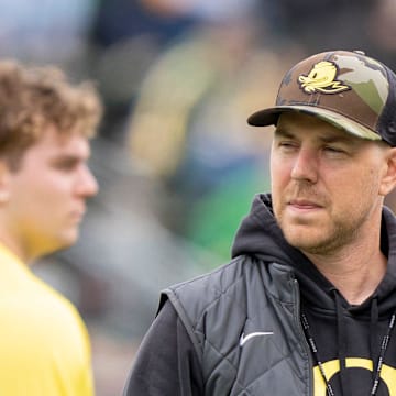 Oregon offensive coordinator Will Stein, left, former Oregon defensive coordinator Nick Aliotti, and former Oregon coach Rich Brooks talk before the game as the Fighting Ducks face off against Mighty Oregon in the Oregon Ducks spring game on April 26, 2025, at Autzen Stadium in Eugene.