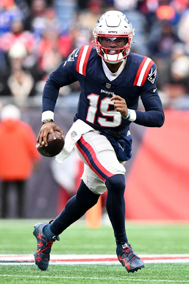 New England Patriots quarterback Joe Milton III runs against the Buffalo Bills during the first half at Gillette Stadium.  