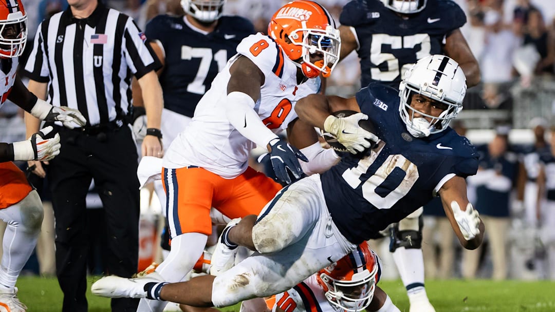 Penn State running back Nick Singleton (10) gets tripped up while carrying the ball in the fourth quarter of a Big Ten football game against Illinois, Saturday, Sept. 28, 2024, in State College, Pa.