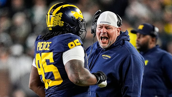 Michigan defensive line coach Lou Esposito talks to defensive lineman Trey Pierce (95) Michigan defensive line coach Lou Esposito talks to defensive lineman Trey Pierce (95)