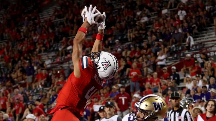 Sep 30, 2023; Tucson, Arizona, USA; Arizona Wildcats wide receiver Tetairoa McMillan (4) makes a touchdown catch against Washington Huskies cornerback Elijah Jackson (25) in the second half at Arizona Stadium.