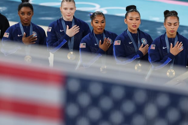 U.S. gymnastics team look on during the national anthem after winning gold in the women's team final at the Paris Olympics.