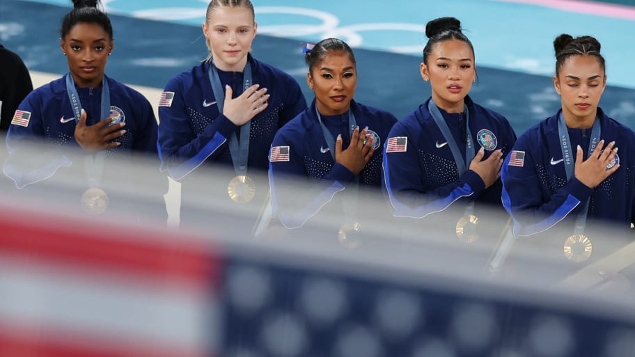 U.S. gymnastics team look on during the national anthem after winning gold in the women's team final at the Paris Olympics.