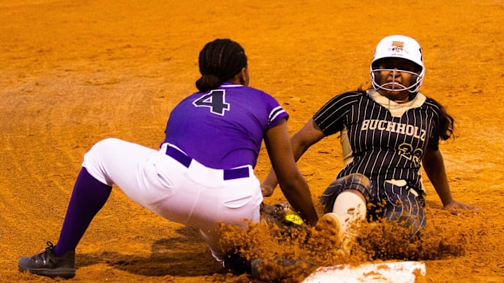Buchholz Bobcats Juliana Abraham (23) slides safe into third in the bottom of the third as Gainesville Hurricanes Michaela Cromarty (4) gets the tag late. Buchholz hosted Gainesville in a crosstown rivalry softball game at Buchholz High School in Gainesville, FL on Wednesday, March 22, 2023. Gainesville defeated Buchholz 15-3 in five innings. [Doug Engle/Gainesville Sun]

Flgai 032423 Ghs Bhs Sb