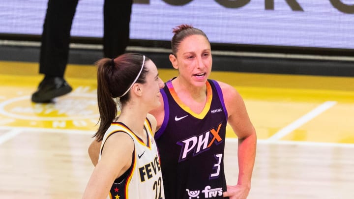 Indiana Fever guard Caitlin Clark (22) and Phoenix Mercury guard Diana Taurasi (3) talk at half court during a free throw on June 30, 2024, at Footprint Center in Phoenix.