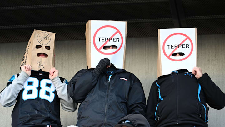 Jan 7, 2024; Charlotte, North Carolina, USA; Carolina Panthers fans Alex Alday, John Alday, and Jon Yonke of Charlotte express their displeasure with Panthers owner David Tepper at Bank of America Stadium.