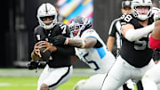 Oct 12, 2025; Paradise, Nevada, USA; Las Vegas Raiders quarterback Geno Smith (7) is sacked by Tennessee Titans linebacker Dre'Mont Jones (45) during the second half at Allegiant Stadium. Mandatory Credit: Stephen R. Sylvanie-Imagn Images