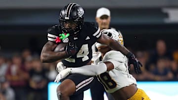 Mississippi State Bulldogs running back Fluff Bothwell (24) runs the ball as Arizona State Sun Devils linebacker Martell Hughes (18) makes the tackle during the fourth quarter at Davis Wade Stadium at Scott Field.