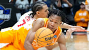 Tennessee Volunteers guard Jordan Gainey (11) and Houston Cougars guard Milos Uzan (7) battle for control of the ball during the second half of a game Sunday, March 30, 2025, during the Elite Eight round of the NCAA March Madness tournament at Lucas Oil Stadium in Indianapolis. Houston defeated Tennessee 69-50.