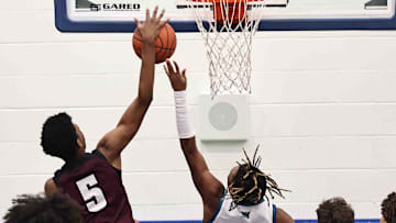 Lebanon forward Anthony Thompson (5) blocks a shot by Winton Woods guard Seaonta Stewart Jr. (3) during their during their 50-61 loss Friday Jan 5 2024.