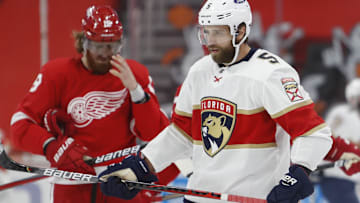 Jan 31, 2021; Detroit, Michigan, USA; Florida Panthers defenseman Aaron Ekblad (5) skates in front of Detroit Red Wings defenseman Marc Staal (18) after scoring a goal during the second period at Little Caesars Arena. Mandatory Credit: Raj Mehta-Imagn Images