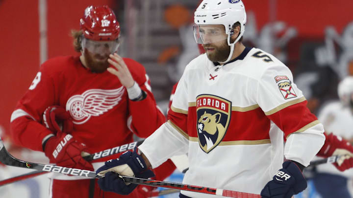 Jan 31, 2021; Detroit, Michigan, USA; Florida Panthers defenseman Aaron Ekblad (5) skates in front of Detroit Red Wings defenseman Marc Staal (18) after scoring a goal during the second period at Little Caesars Arena. Mandatory Credit: Raj Mehta-Imagn Images