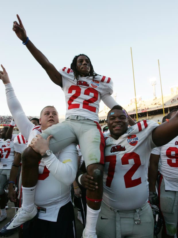 Mississippi Rebels center Daverin Geralds, right, hoists running back Dexter McCluster after the 2009 Cotton Bowl Classic.