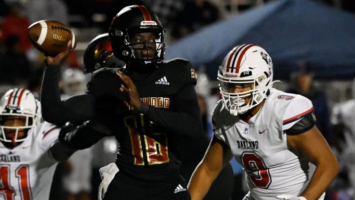Ravenwood quarterback Femi Babalola (16) passes as Oakland   s Quentin Norfolk (9) moves in during an high school football game Friday, Oct. 20, 2023, in Brentwood, Tenn.