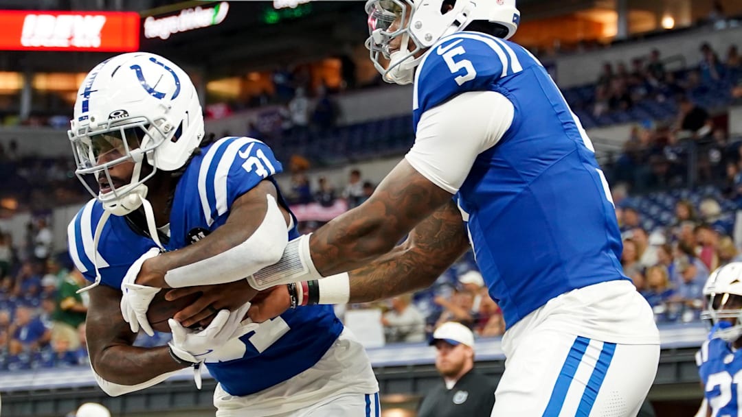 Aug 16, 2025; Indianapolis, Indiana, USA; Indianapolis Colts running back Tyler Goodson (31) receives a handoff from Indianapolis Colts quarterback Anthony Richardson Sr. (5) during warmups prior to the game against the Green Bay Packers at Lucas Oil Stadium. Mandatory Credit: Robert Goddin-Imagn Images