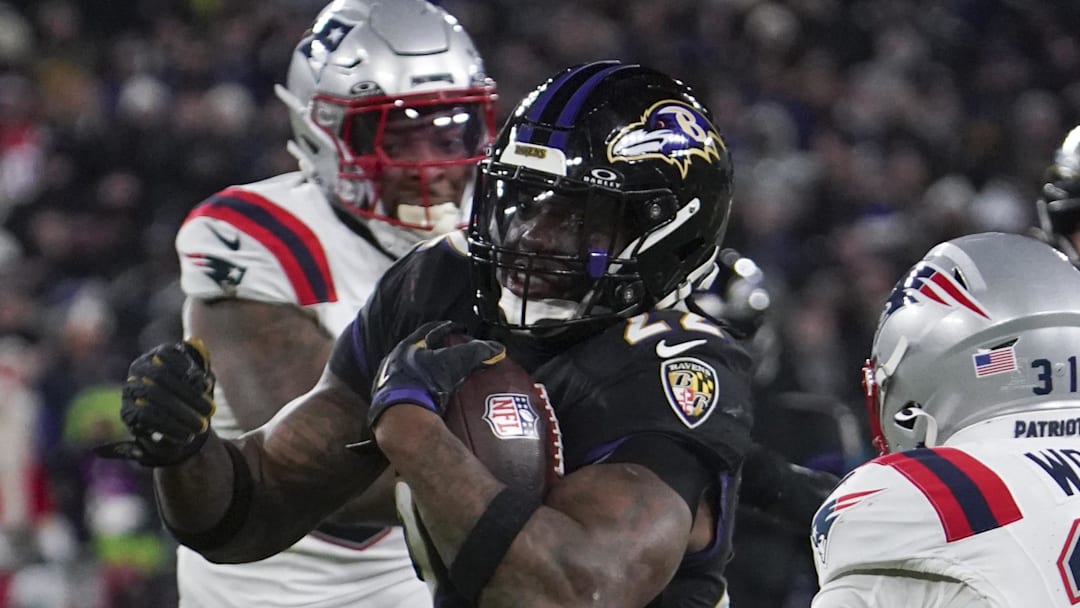 Baltimore Ravens running back Derrick Henry runs the ball against New England Patriots safety Craig Woodson.
