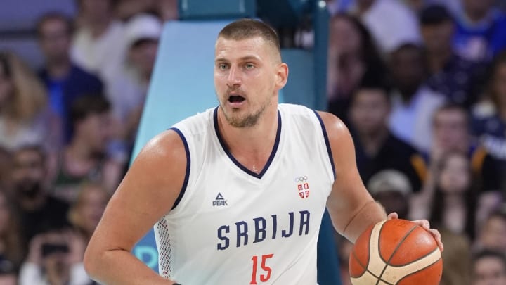 Jul 28, 2024; Villeneuve-d'Ascq, France; Serbia power forward Nikola Jokic (15) dribbles in the fourth quarter against the United States during the Paris 2024 Olympic Summer Games at Stade Pierre-Mauroy. 