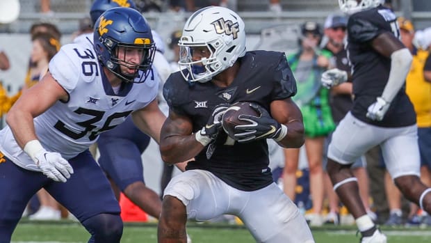 UCF Knights running back RJ Harvey on a rushing attempt during a college football game in the Big 12.