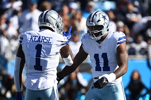 Dallas Cowboys linebacker Micah Parsons celebrates with safety Jayron Kearse after making a sack.