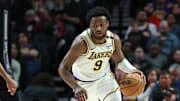 Apr 13, 2025; Portland, Oregon, USA; Los Angeles Lakers guard Bronny James (9) brings the ball up the court past Portland Trail Blazers forward Kris Murray (24) in the second half at Moda Center. Mandatory Credit: Jaime Valdez-Imagn Images