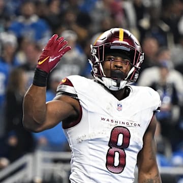 Washington Commanders running back Brian Robinson Jr. celebrates a touchdown against the Detroit Lions