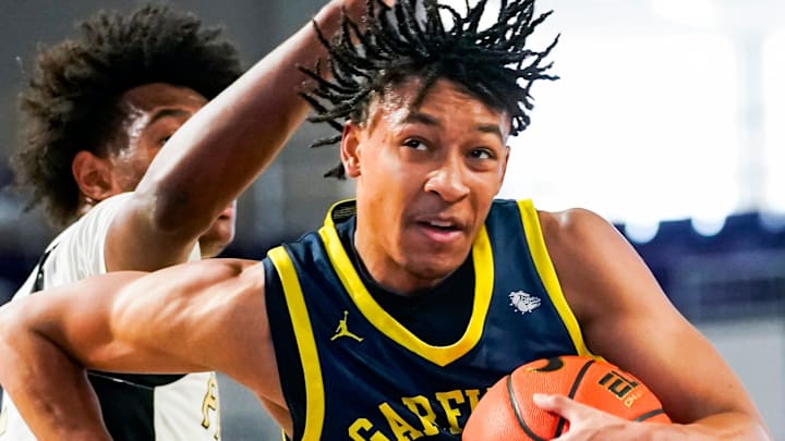 Garfield Heights Bulldogs guard Marcus Johnson (11) drives to the basket during the second quarter of the City of Palms Classic first round game against the Paul VI Panthers at Suncoast Credit Union Arena in Fort Myers, Fla., on Thursday, Dec. 18, 2025.