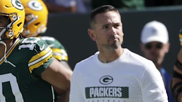 Sep 29, 2024; Green Bay, Wisconsin, USA;  Green Bay Packers quarterback Jordan Love (10) and head coach Matt LaFleur walk onto the field before the game against the Minnesota Vikings at Lambeau Field. Mandatory Credit: William Glasheen/USA TODAY Network via Imagn Images